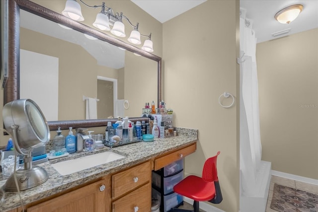 bathroom with tile patterned floors and vanity