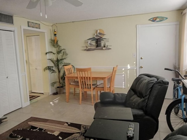 tiled dining area with ceiling fan