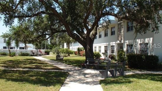 view of home's community with a lawn