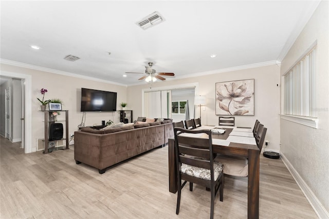 dining area with ceiling fan, crown molding, and light wood-type flooring