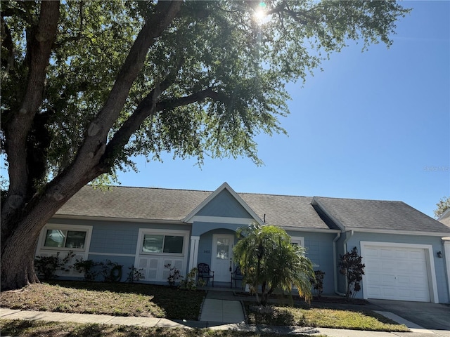 8465 Oak Bluff Dr, Orlando, FL 32827 - ranch-style home featuring driveway, a shingled roof, and a garage