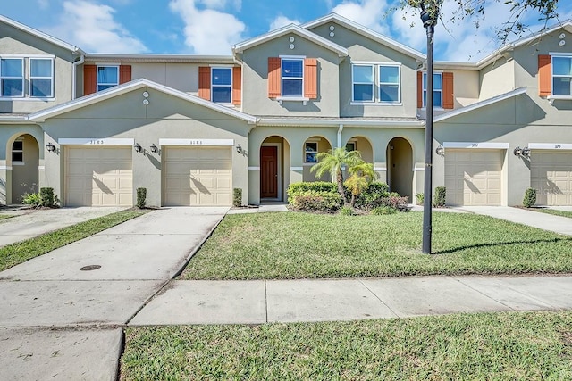 view of property with a front yard and a garage