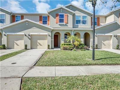 view of front of home with a front lawn and a garage