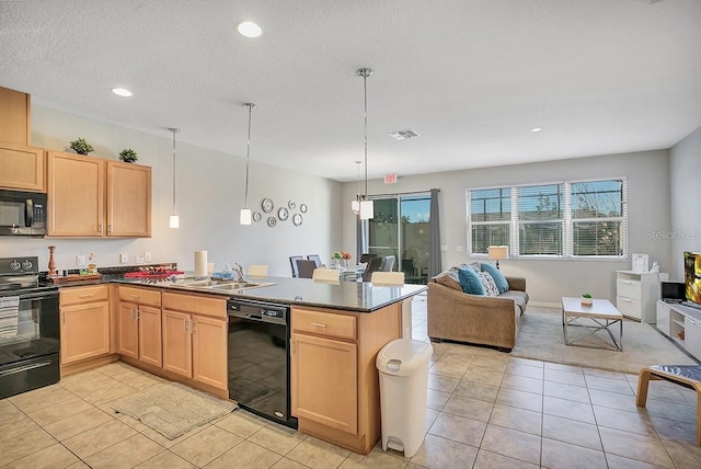 kitchen featuring light tile patterned floors, black appliances, pendant lighting, and kitchen peninsula