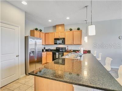 kitchen featuring sink, decorative light fixtures, light tile patterned flooring, kitchen peninsula, and black appliances