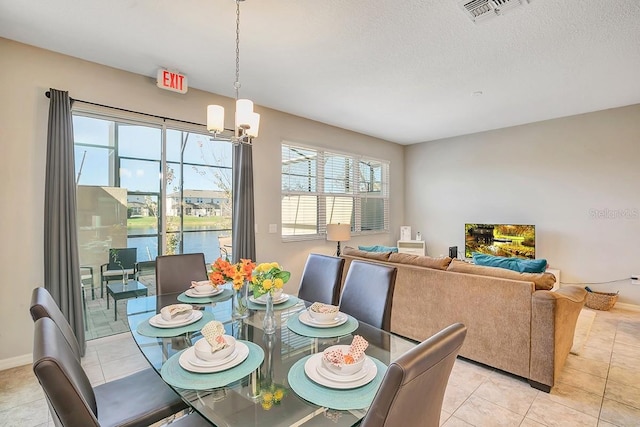 tiled dining space with a notable chandelier