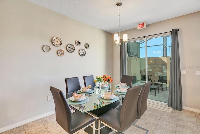 dining room featuring light tile patterned floors and a chandelier