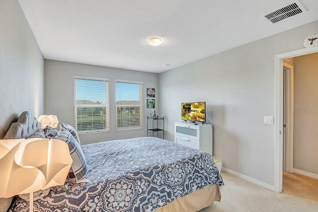 bedroom with light colored carpet