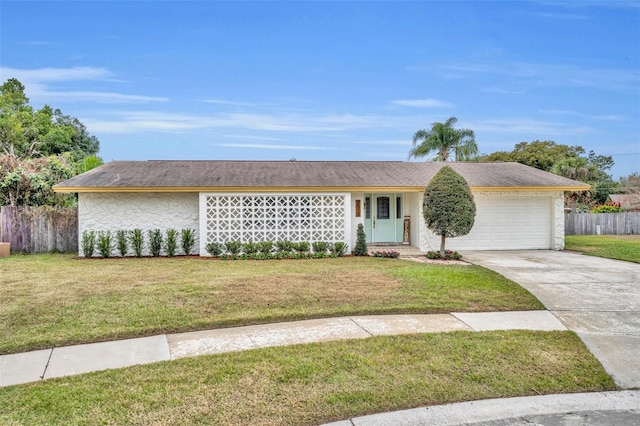 ranch-style house featuring a front yard and a garage