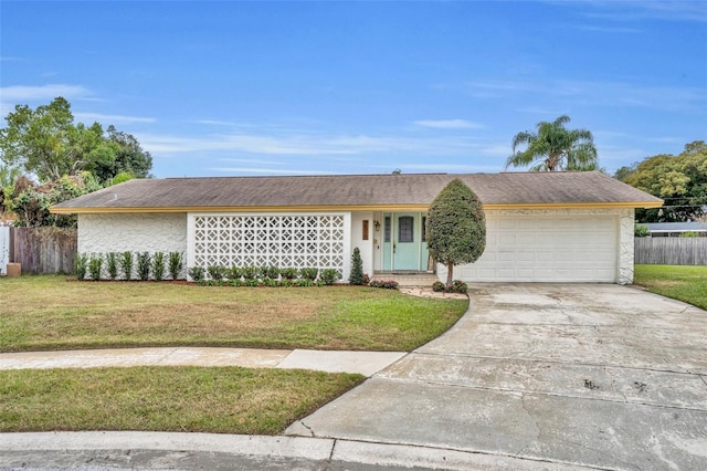 single story home with a garage and a front lawn