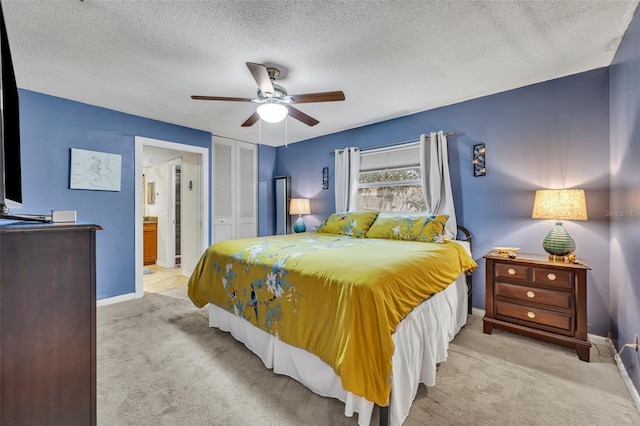 carpeted bedroom featuring ceiling fan, a textured ceiling, and a closet