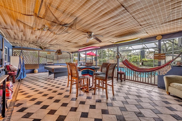 sunroom featuring ceiling fan and pool table