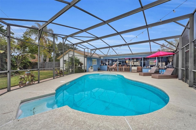 view of swimming pool featuring a lanai and a patio