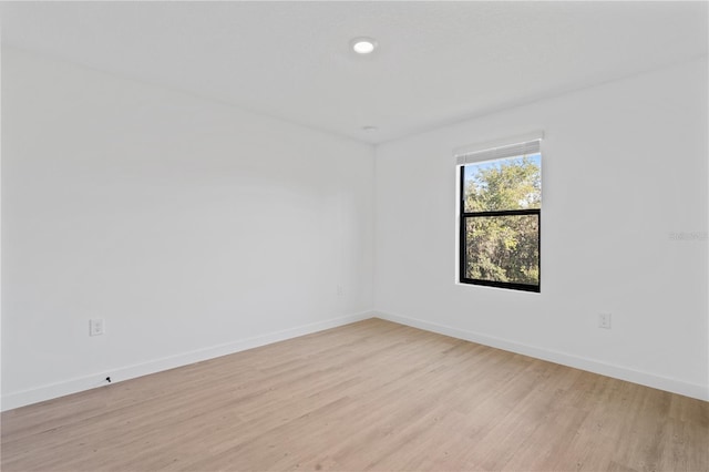 empty room with light hardwood / wood-style flooring