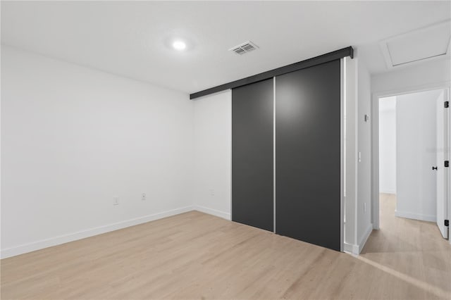 unfurnished bedroom featuring a closet and light hardwood / wood-style flooring