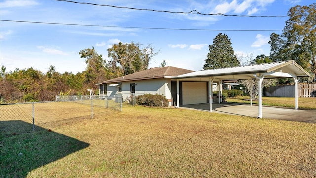 exterior space featuring a garage, a carport, and a yard