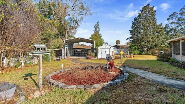 view of yard featuring a carport and a storage unit