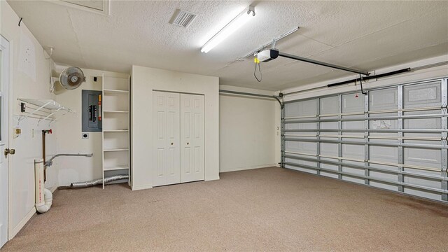 garage with electric panel and a garage door opener