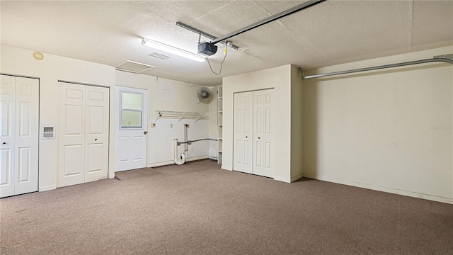 unfurnished bedroom featuring a textured ceiling, multiple closets, carpet flooring, and ceiling fan