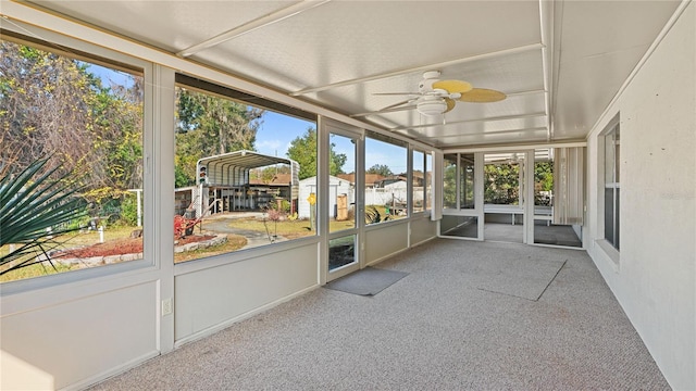 unfurnished sunroom with ceiling fan and a healthy amount of sunlight