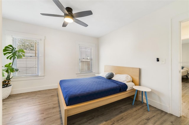 bedroom with wood-type flooring and ceiling fan