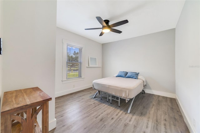 bedroom with ceiling fan and light wood-type flooring