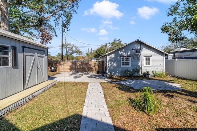 view of yard featuring a patio and a storage shed