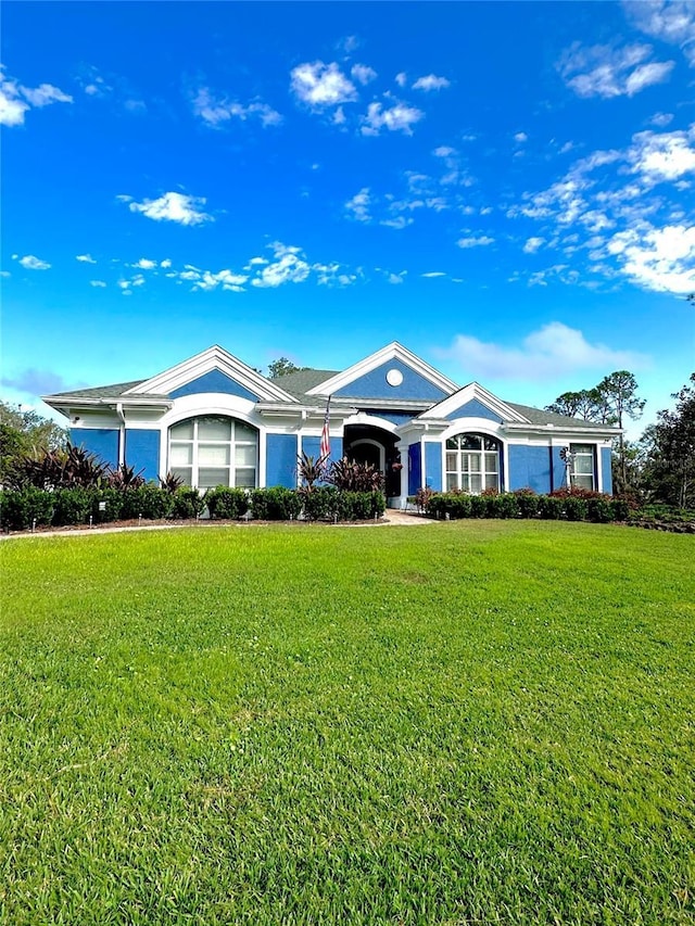 ranch-style home with a front lawn