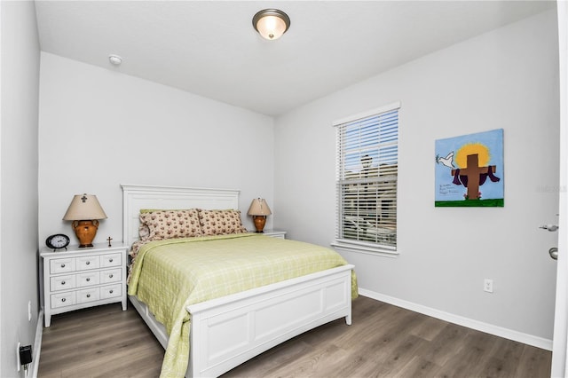 bedroom with dark hardwood / wood-style flooring