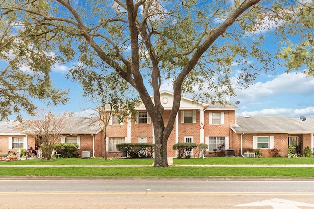 greek revival inspired property featuring central AC and a front yard