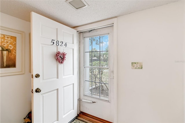 entryway featuring a textured ceiling