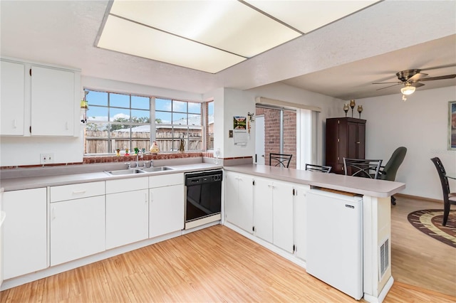 kitchen with white cabinetry, kitchen peninsula, fridge, dishwasher, and sink