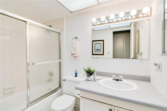 full bathroom with toilet, vanity, enclosed tub / shower combo, and a textured ceiling