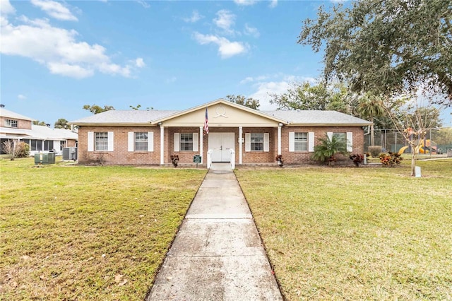 view of front of home with a front lawn and central air condition unit