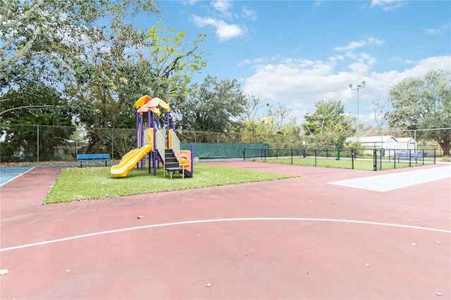 view of playground with tennis court and basketball hoop