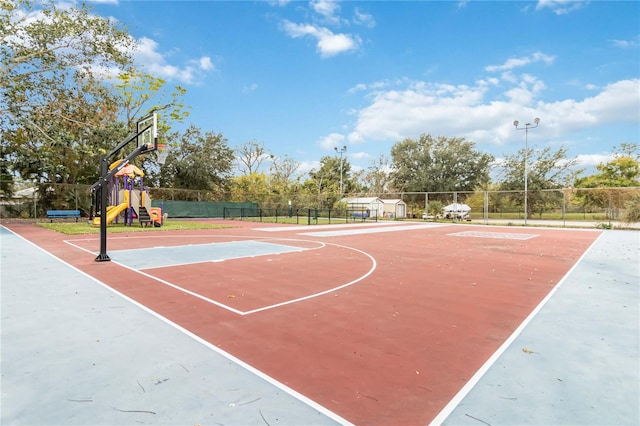 view of sport court with a playground