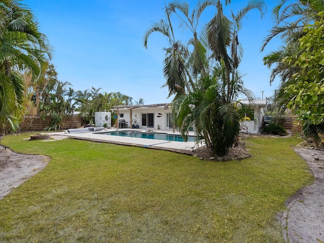 view of yard with a patio area and a fenced in pool