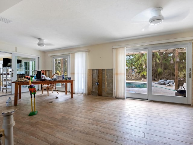 office with ceiling fan, a healthy amount of sunlight, and hardwood / wood-style flooring