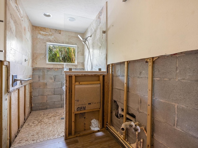 bathroom with hardwood / wood-style floors and walk in shower