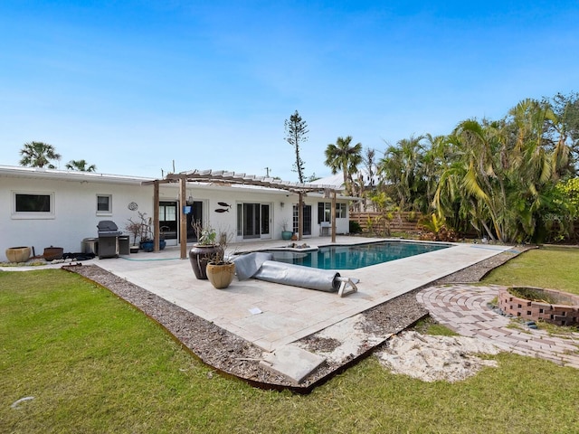 view of pool with a pergola, a patio area, and a lawn