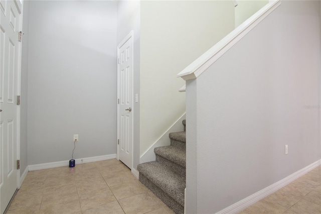 stairway featuring tile patterned floors