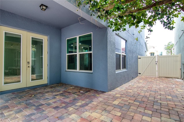 view of property exterior featuring a patio area and french doors