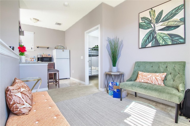 living area featuring light colored carpet