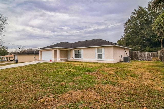 single story home featuring central AC unit, a front yard, and a garage