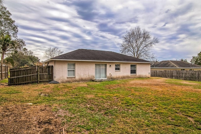 rear view of property with a yard