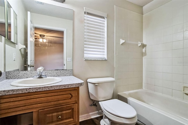 full bathroom featuring toilet, tiled shower / bath combo, and vanity