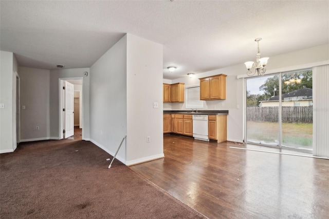 kitchen featuring a textured ceiling, a chandelier, decorative light fixtures, white dishwasher, and dark colored carpet