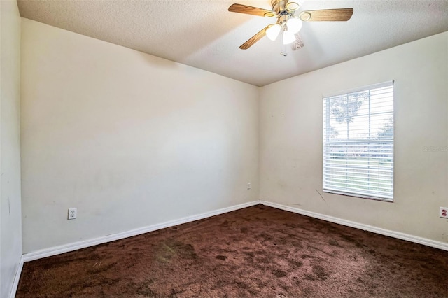 spare room with ceiling fan, carpet floors, and a textured ceiling