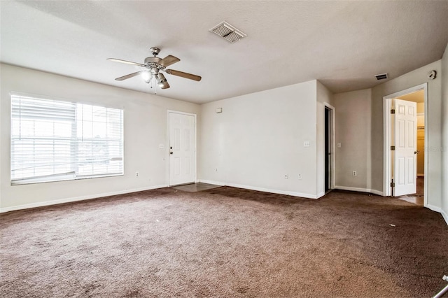 carpeted spare room with ceiling fan