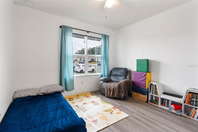 bedroom with light hardwood / wood-style flooring and ceiling fan